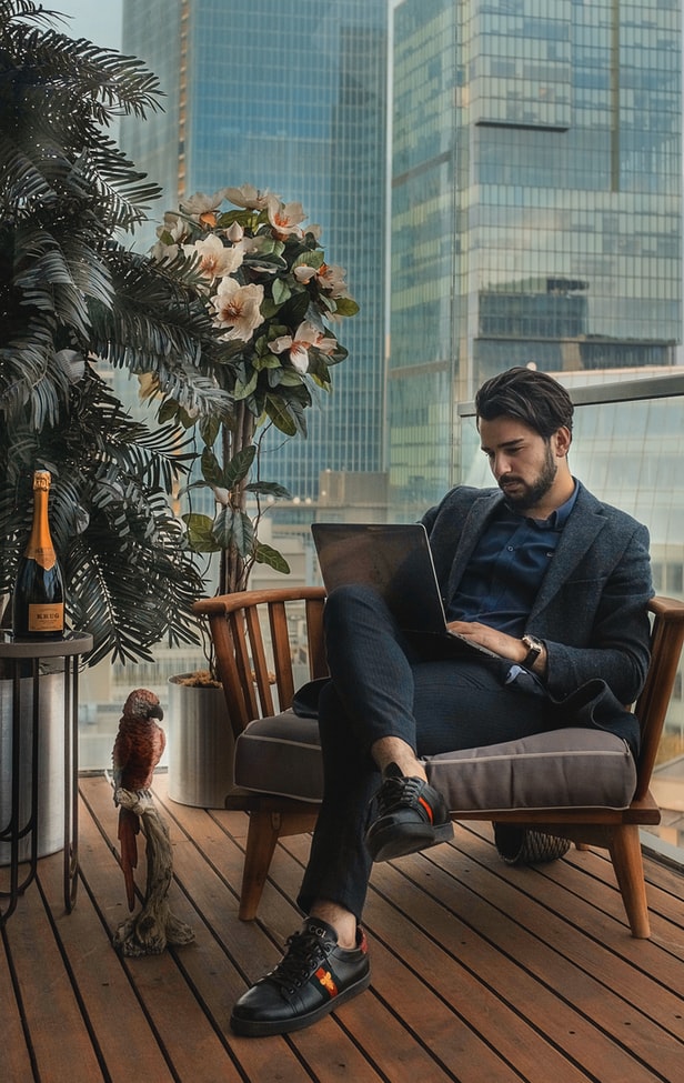 A businessman using a laptop outside.