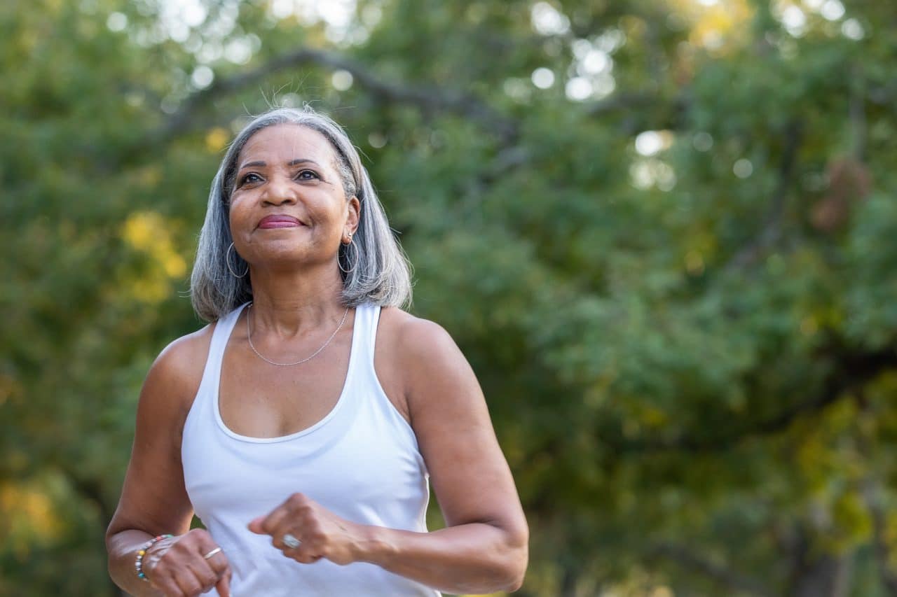 Woman jogging in public park.