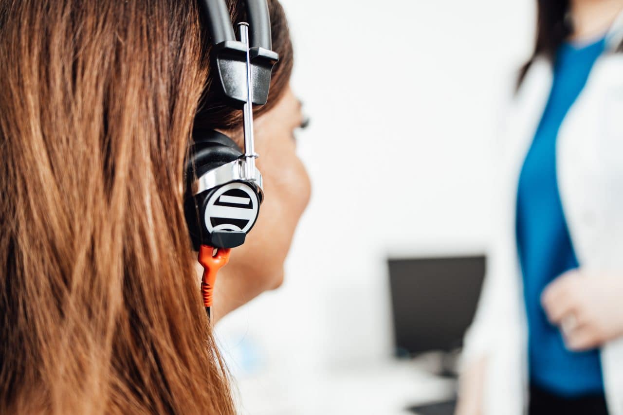 Woman wearing headphones and taking a hearing test.