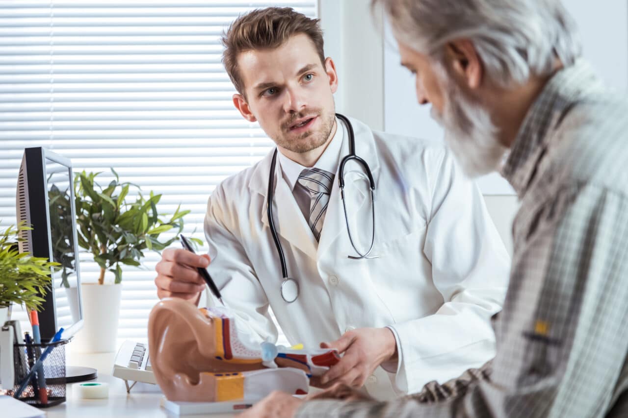 Doctor talking to an older patient about hearing loss.