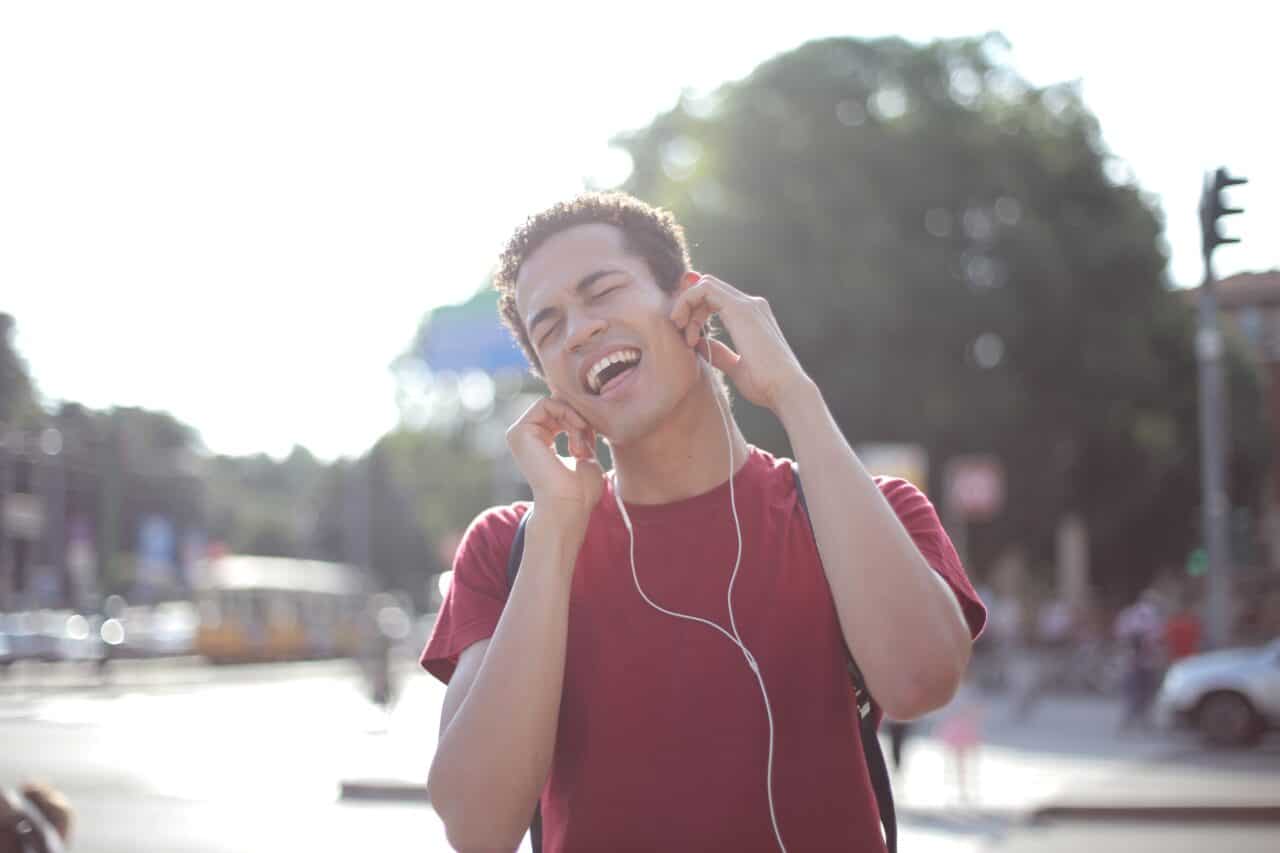 Young man listening to music on headphones.