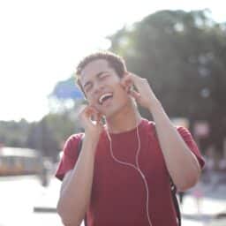 Young man listening to music on headphones.