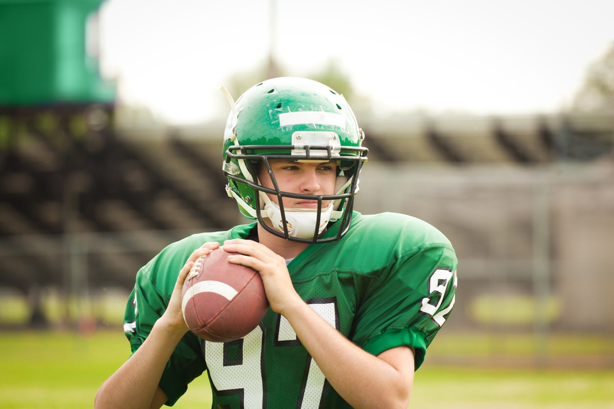 Football player holding ball during game