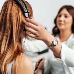 Young woman about to start a hearing test