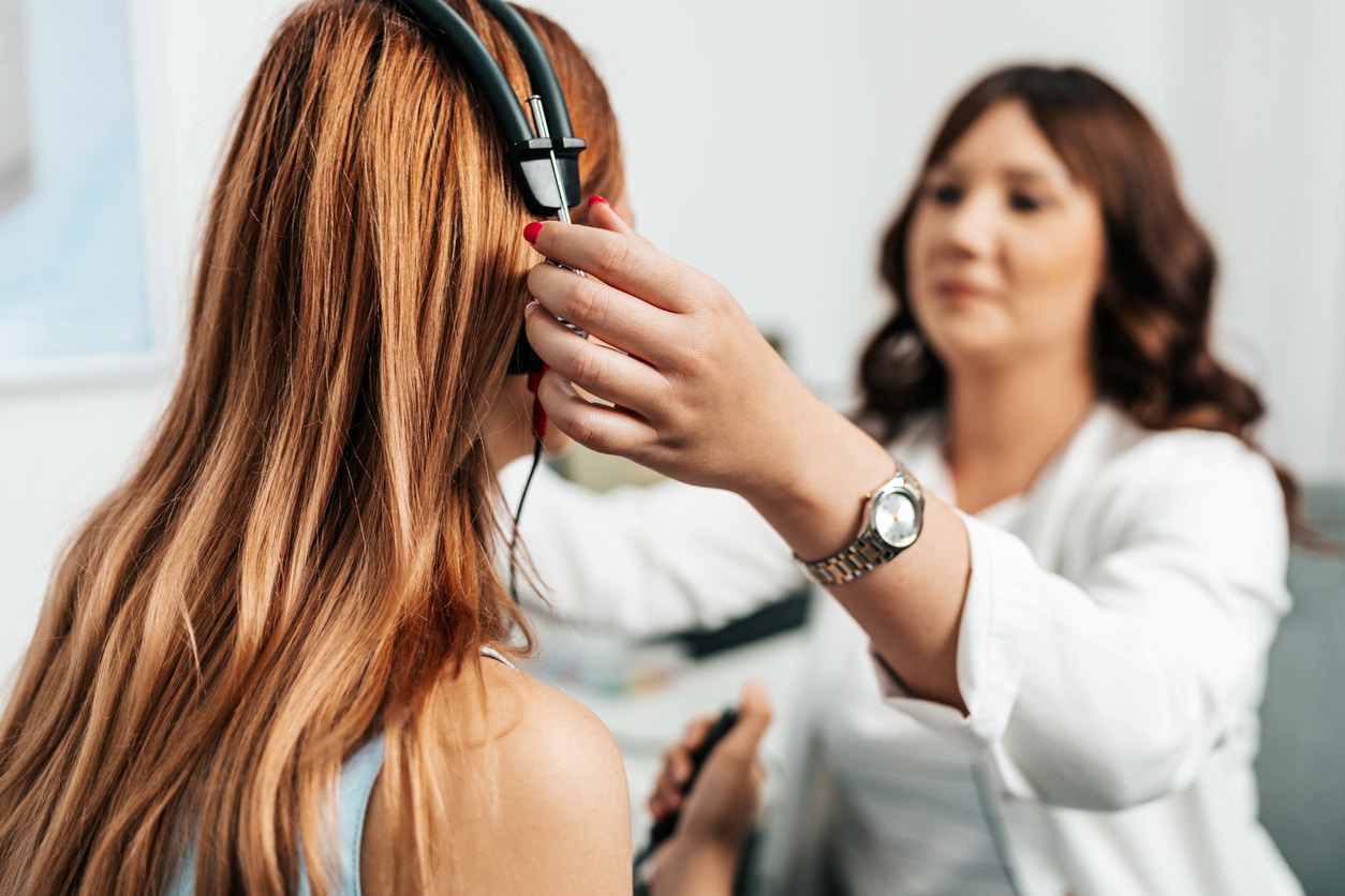 Young woman about to start a hearing test.