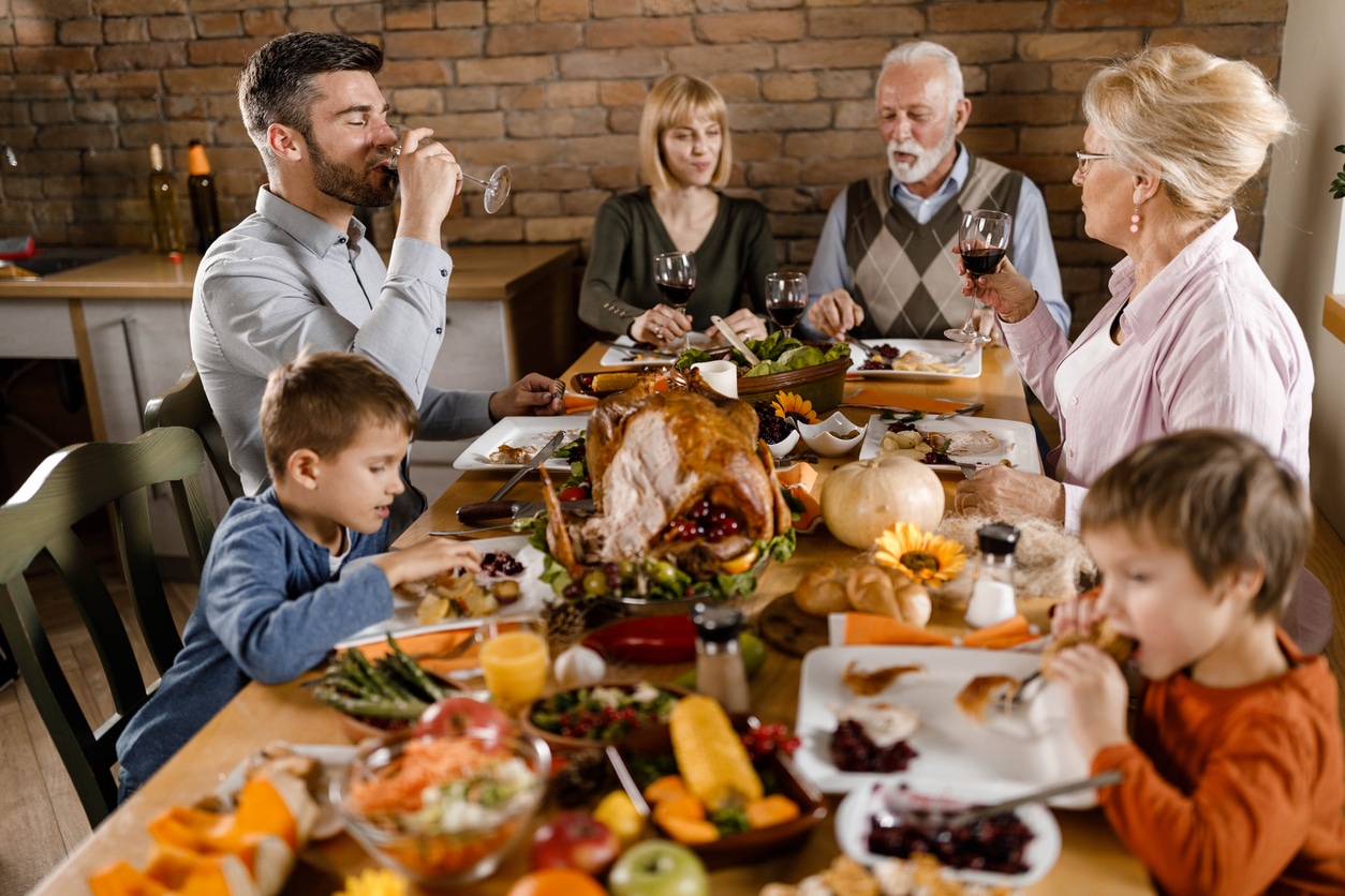 Happy family enjoying Thanksgiving dinner together 